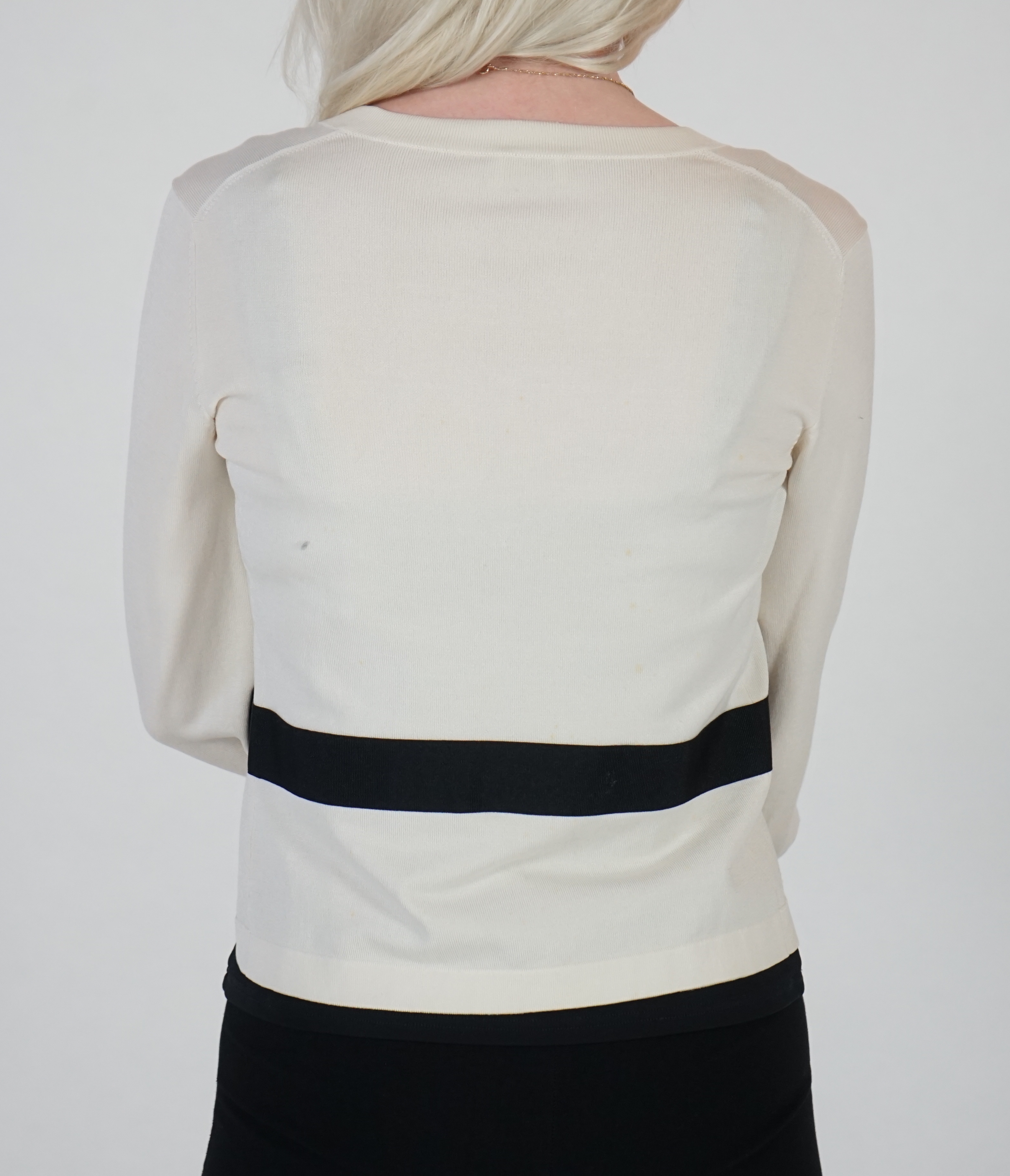 A white Valentino jacket with black camisole